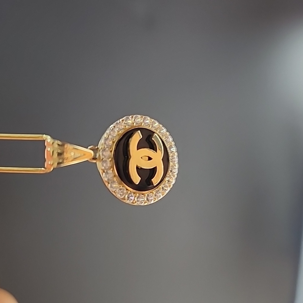 14k solid yellow gold. cc pendant ½ inch. Zirconias. Black enamel. Just pendant